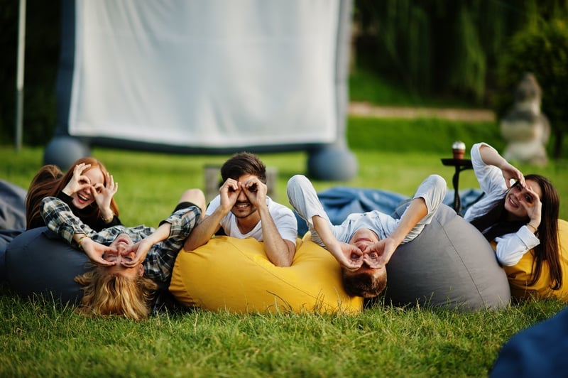 people sitting together on bean bags to watch a movie