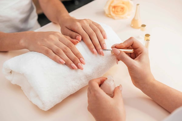 Woman getting a manicure at a salon