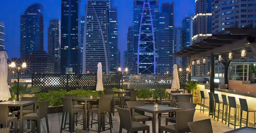 outdoor patio with outdoor seating and bar ofarmada avenue hotel