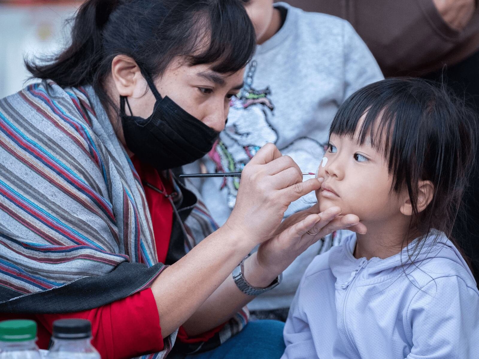 child receiving a face painting