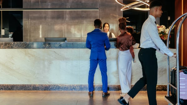 two people checking into a hotel