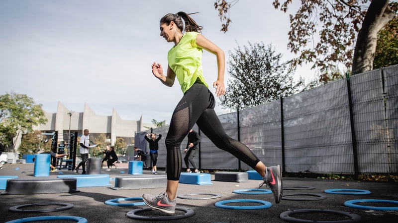 Woman working out in outdoor gym to stay fit and healthy at JLT park.