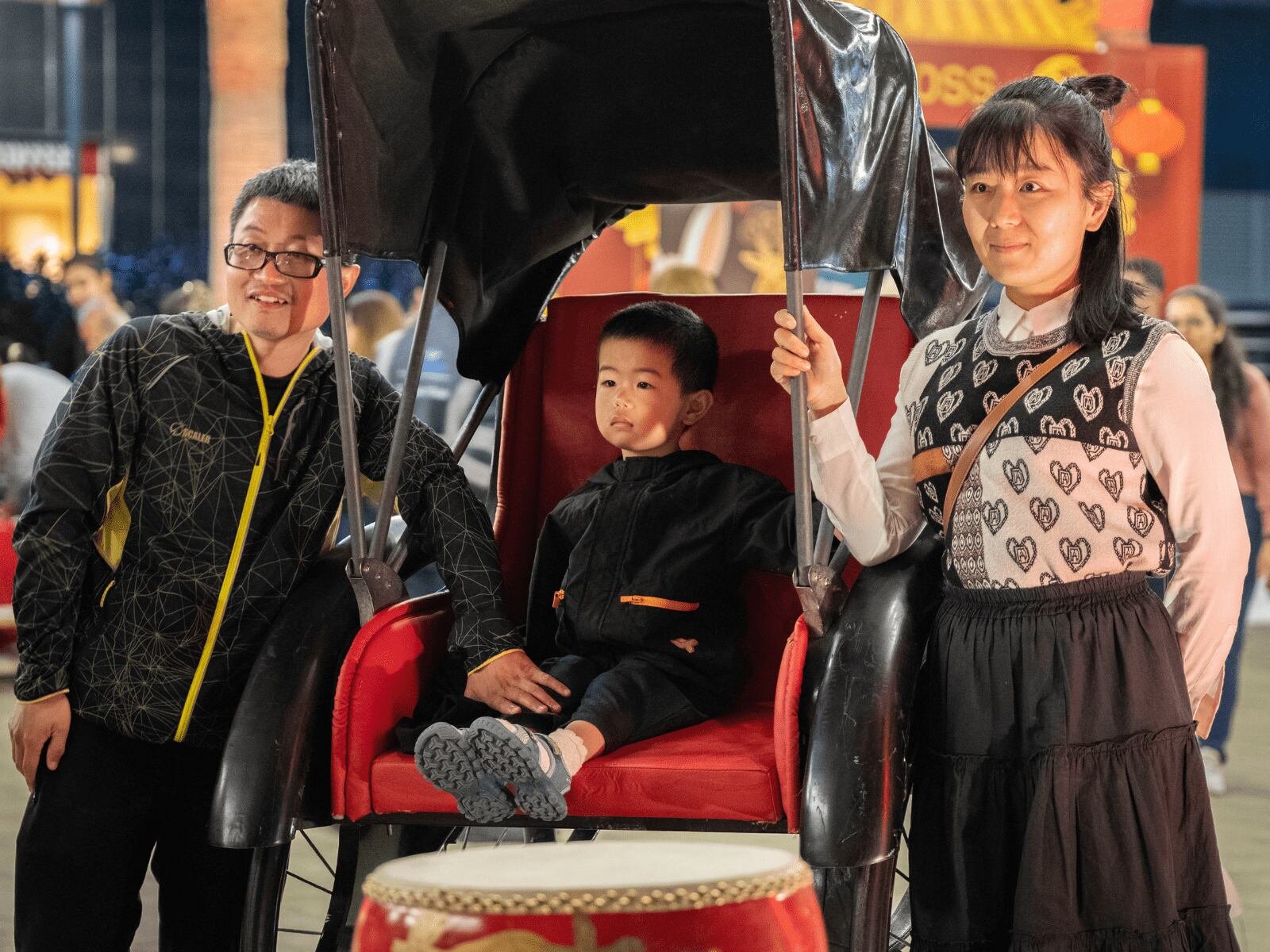 a family photo with a child in a rickshaw
