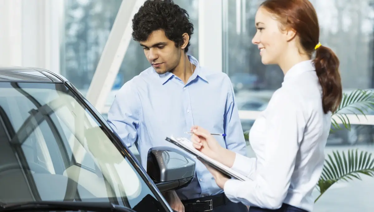 man inspecting a car with assisting