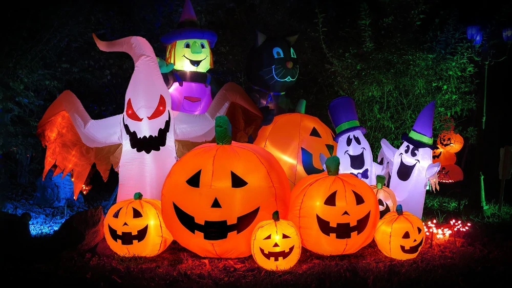 Halloween decorations of pumpkins, ghosts, and bats in garden at JLT park.